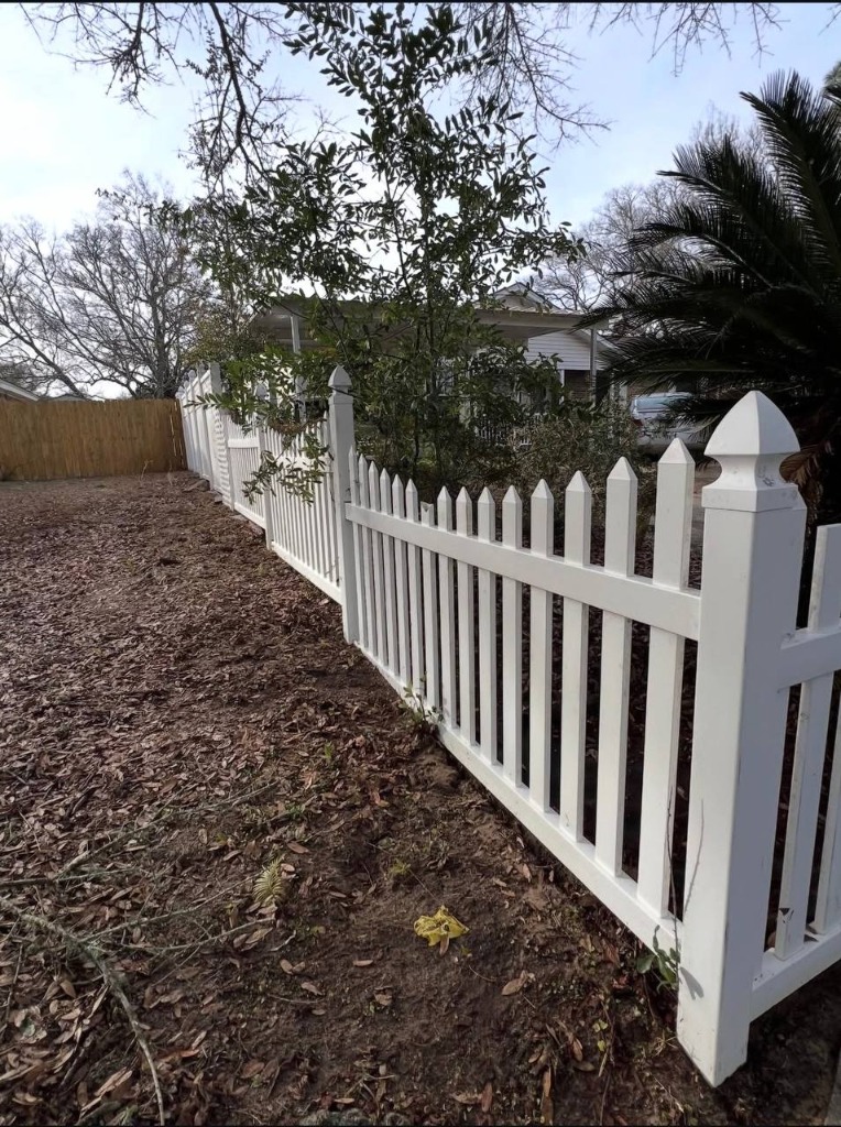 Clean white picket fence after soft wash