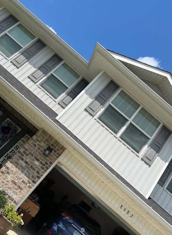 Clean house front and roofline after exterior wash